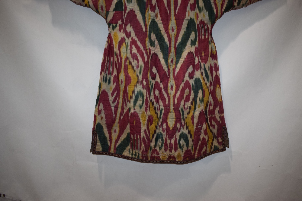 Uzbek silk ikat chapan, Uzbekistan, early 20th century, lined with printed cotton. With wear and - Image 10 of 11