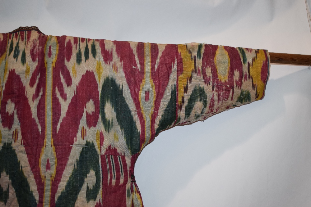 Uzbek silk ikat chapan, Uzbekistan, early 20th century, lined with printed cotton. With wear and - Image 9 of 11