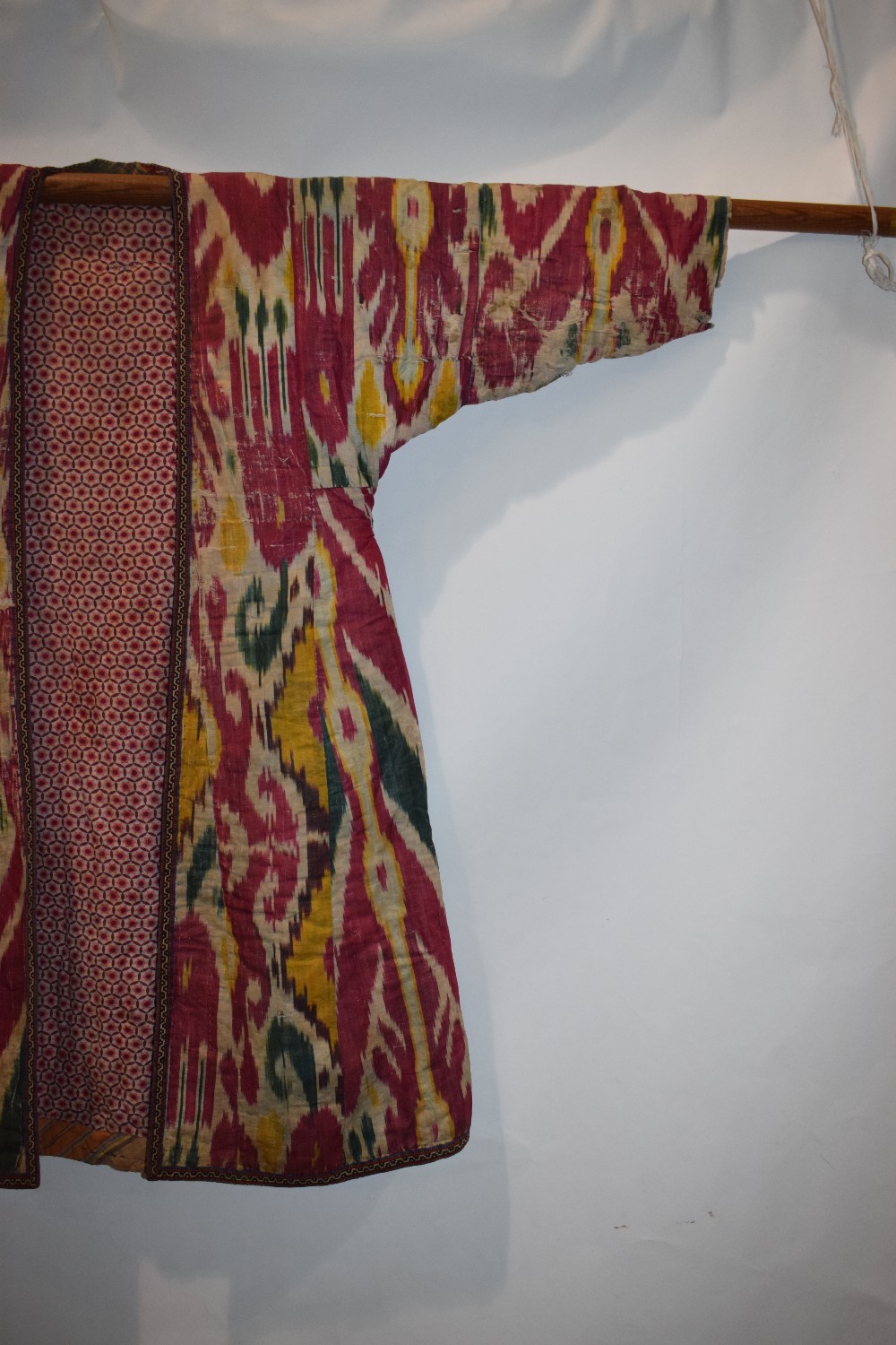 Uzbek silk ikat chapan, Uzbekistan, early 20th century, lined with printed cotton. With wear and - Image 3 of 11