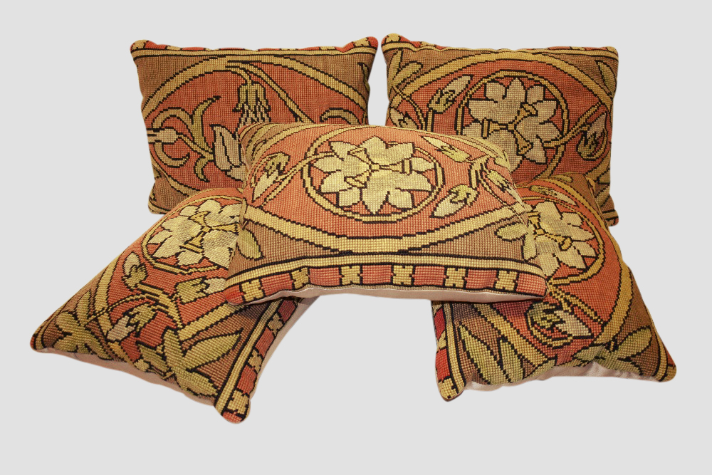 Five needlework cushions each worked with a flowerhead, each 15in. X 12in. 38cm. X 30cm. With