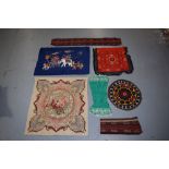 Group of seven textiles comprising Uzbek circular mat, a green silk panel, and a red felted square