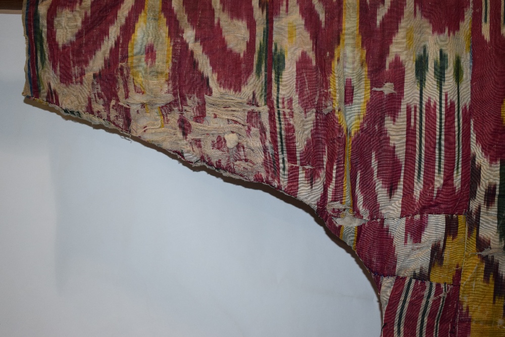 Uzbek silk ikat chapan, Uzbekistan, early 20th century, lined with printed cotton. With wear and - Image 5 of 11
