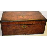 A Victorian figured walnut veneered lap desk, brass bound, the hinged lid with an inscribed brass