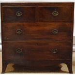 A Regency mahogany veneered commode chest of two short and two long graduated drawers, with replaced