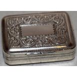 A George IV silver rectangular vinaigrette, the hinged lid and base engraved with a foliage