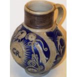 An early eighteenth century German Westwewald saltglaze jug, with blue scrolling foliage, the