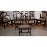 A set of eight mahogany dining chairs in Hepplewhite style, the backs with palmette capped