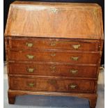 A mid eighteenth century walnut veneered and oak bureau, feather banded, the fall flap reveals a