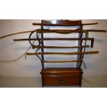 A Victorian mahogany whip rack and spurs stand, the shaped tapering sides, with a shape