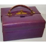 A George V ladies travelling toilet Portmateau case, covered in mauve leather, the double hinged top