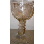 A large nineteenth century glass banqueting goblet, the bowl engraved with wild roses, on a hollow