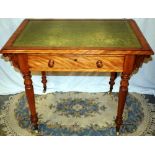 A Victorian satin walnut ladies writing table, the rectangular top inset green leather, the frieze