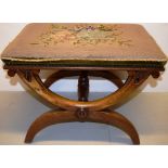 A Victorian walnut 'X' frame stool, the padded nailed needlework rectangular seat on hooped walnut
