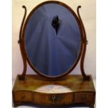 A George III mahogany oval swing toilet mirror, with a veneered serpentine fronted box base,