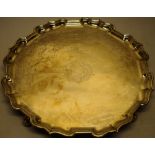 A George II silver circular salver, the centre engraved a Coat of Arms, a raised 'bath' edge moulded