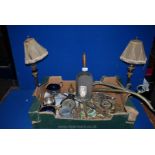 A box of brass to include two brass table lamps, shovel, horse brasses, etc.