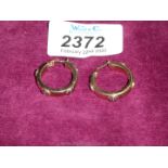 A pair of 9 ct. gold hoop style earrings.