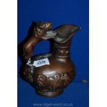 A Copper Romanesque Style Ornament in the Form of a Ewer Decorated with Embossed Naked Dancers with