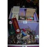 A pink box full of costume jewellery.