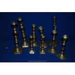 Four pairs of brass Candlesticks to include some with pushers,