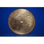 A large circular brass Tray with scalloped edge, 22" diameter.