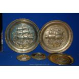 Five brass wall plaques with embossed galleons, various sizes.