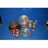 A quantity of metalware including brass frying pans, a pair of pewter goblets, small copper jugs,