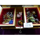 A wooden musical jewellery Box with costume brooches, clip-on earrings and necklaces, etc.