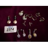 Five pairs of white metal earrings for pierced ears.