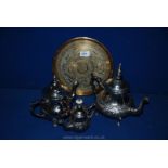 Three white metal teapots and a brass salver of Moorish/Arabic design.