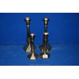 Two matching pairs of Art Deco brass candlesticks with hexagonal bases and body,
