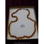 An amber necklace, 22" long.