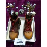 Two novelty shoes including 38 hat pins.