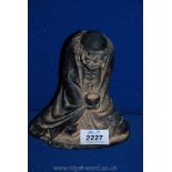 An Oriental Patinated Metal Figure of a Balding Beggar Sat Cross Legged with Empty Bowl in Hand -