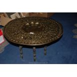 A large heavily embossed Benares table and stand, 30" diameter.