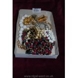 A quantity of costume jewellery to include scarf clips, etc.