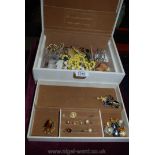 A Jewellery box containing costume jewellery including brooches, bead necklaces, earrings, etc.