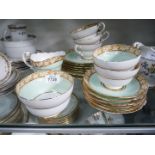 A Paragon part Teaset, pale green and floral borders with floral decoration on base.