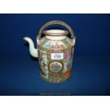 A highly decorated Canton Teapot having butterflies and bird decoration and oriental figures.