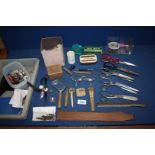 A tray of miscellanea including scissors, magnifier, darning tools, crochet, tape measures,