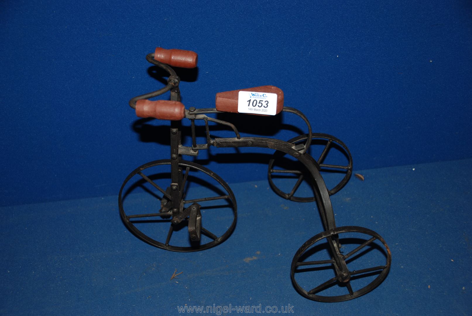 A small replica child's toy Bike, metal with three wheel.