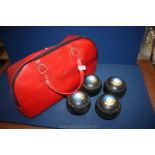 A red bag of mixed Bowling bowls.