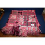 A double pink/black Welsh blanket in excellent condition.