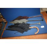 Three Victorian silk umbrellas one having mother of pearl handle and a gents umbrella with bamboo