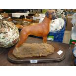 A figure of Boxer dog on wooden plinth (V. Griffiths).