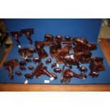 A quantity of wooden African elephants including elephant head bookends, tusks missing,