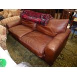 A three/four seater brown Leather upholstered Settee