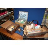 A box of needle craft items to include a wicker sewing box, small leather suitcase,