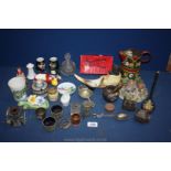 A box of miscellanea to include painted metal water can, miniature cottages, clippers,