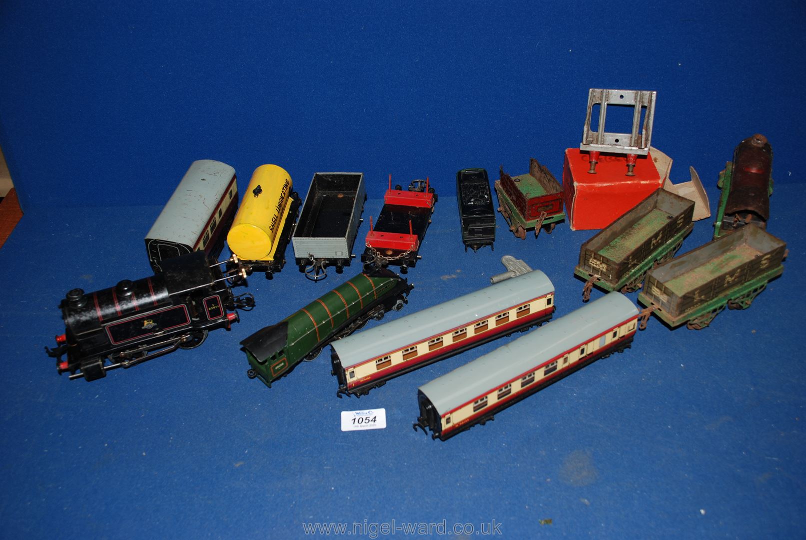 A box of vintage trains to include; Silver King carriages, British railways, etc.